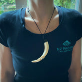 Hand carved Boars Tusk pendant with Buffalo horn, Paua Shell and Brass. Engraved large boars tusk pendant. Unisex necklace hand carved by Andrew Doughty here in New Zealand. Unique art to wear. Delivered with an adjustable black cord.